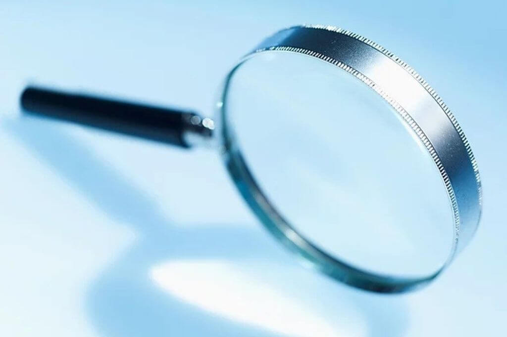 Magnifying glass on a blue table