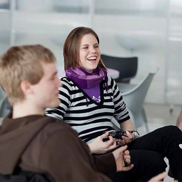 People sat talking and laughing in a group