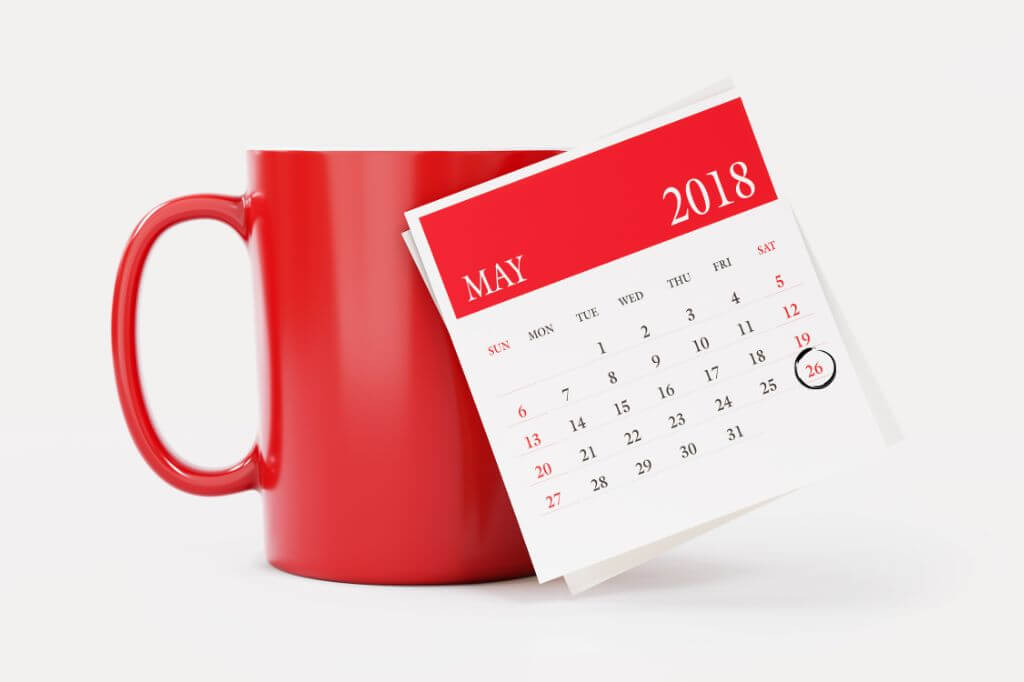 Red mug with a red and white calendar of May 2018 with the date 26th circled