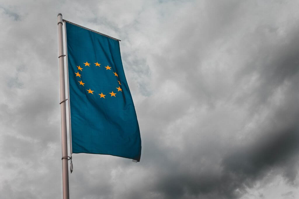 EU flag flying on grey skies