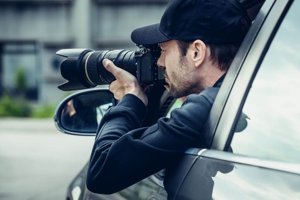 Paparazzi in car snapping a photograph
