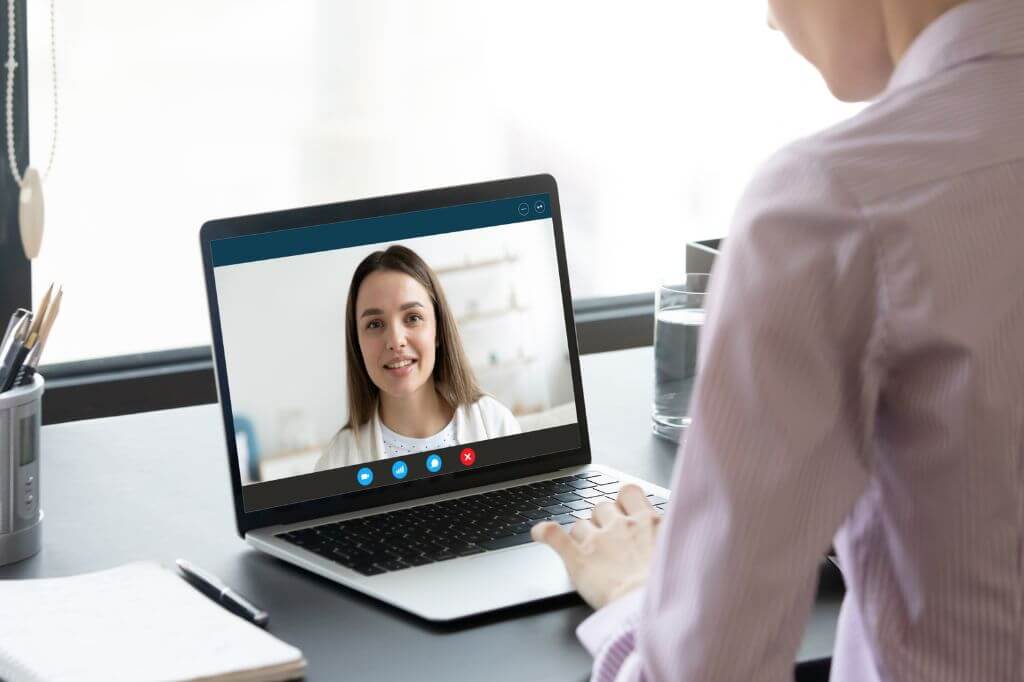 Manager talking to colleague on video call