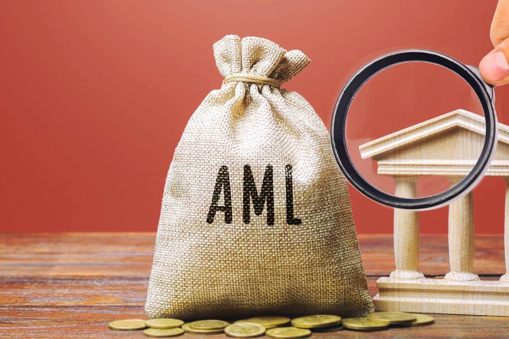 Money bag with the letters AML on the front and a magnifying glass
