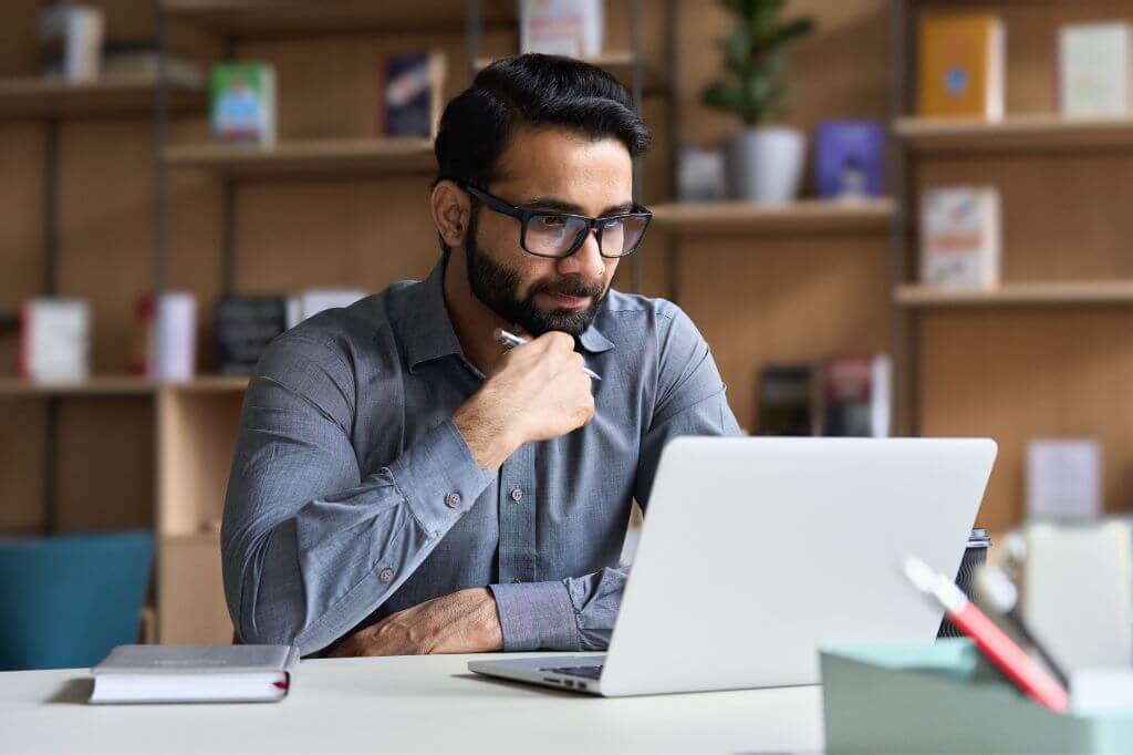 Man watching a webinar intently