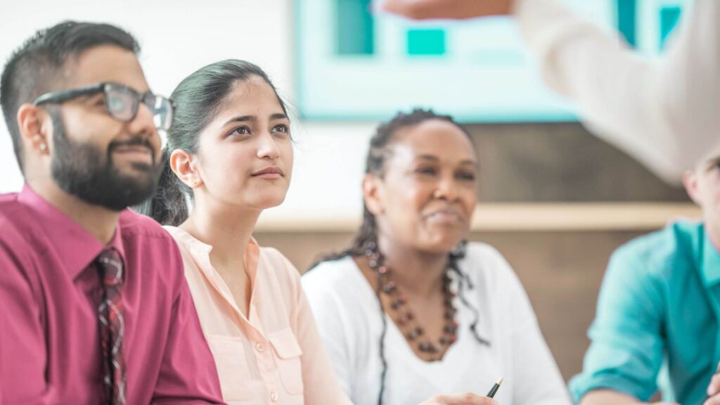 3 delegates sat in a training seminar